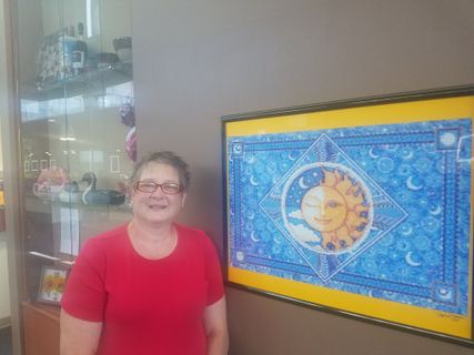 Beth ann mccormick in front of her artwork