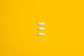 Pills on a yellow background