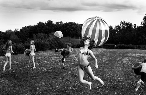 black and white photo of kids playing with ball