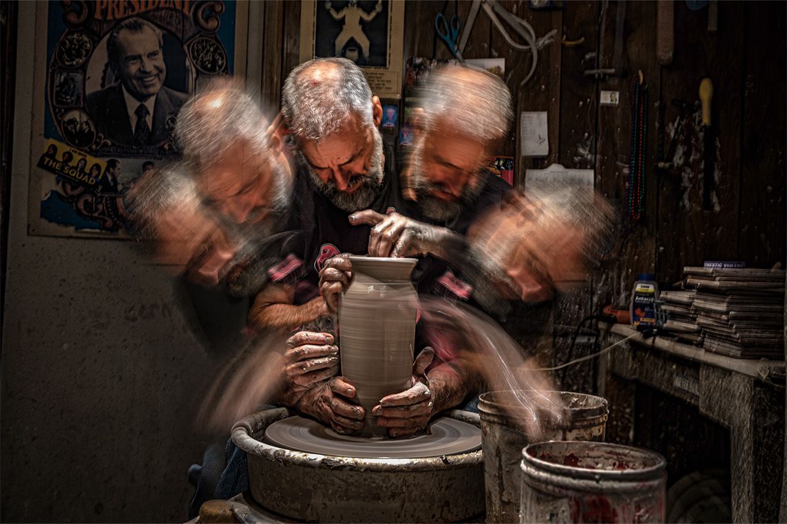 Long exposure photo of man making pottery