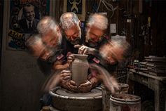 Long exposure photo of man doing pottery