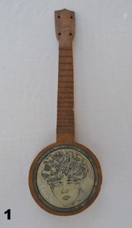 banjo with drawing of face
